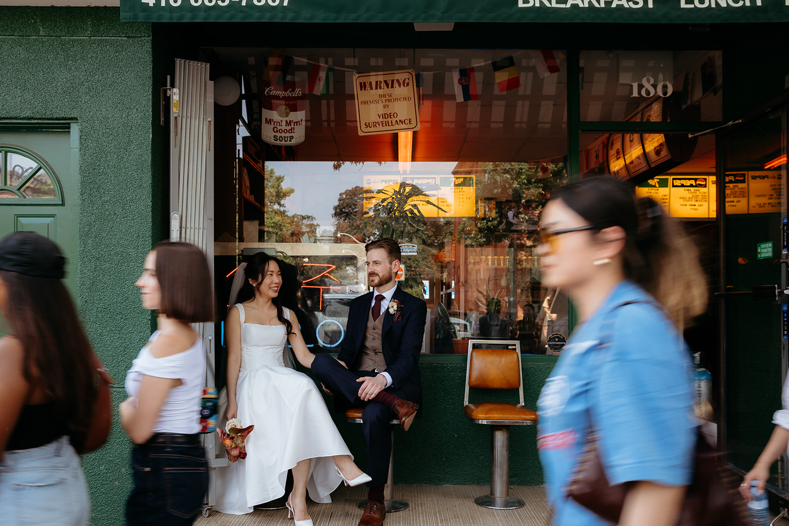 wedding portraits on Ossington Avenue Toronto with motion blur crowd
