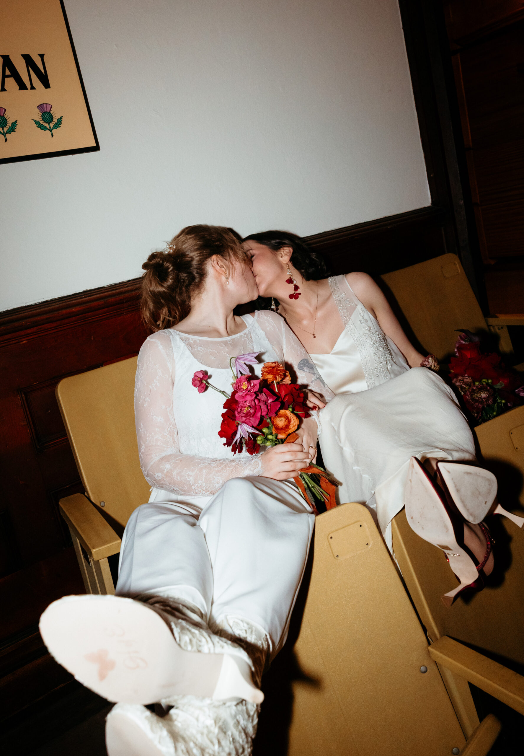 wedding portraits in theatre seating overlooking reception at Arts and Letters Club